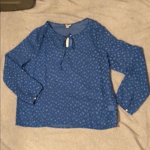 Blue sheer blouse with tie detail at the top.